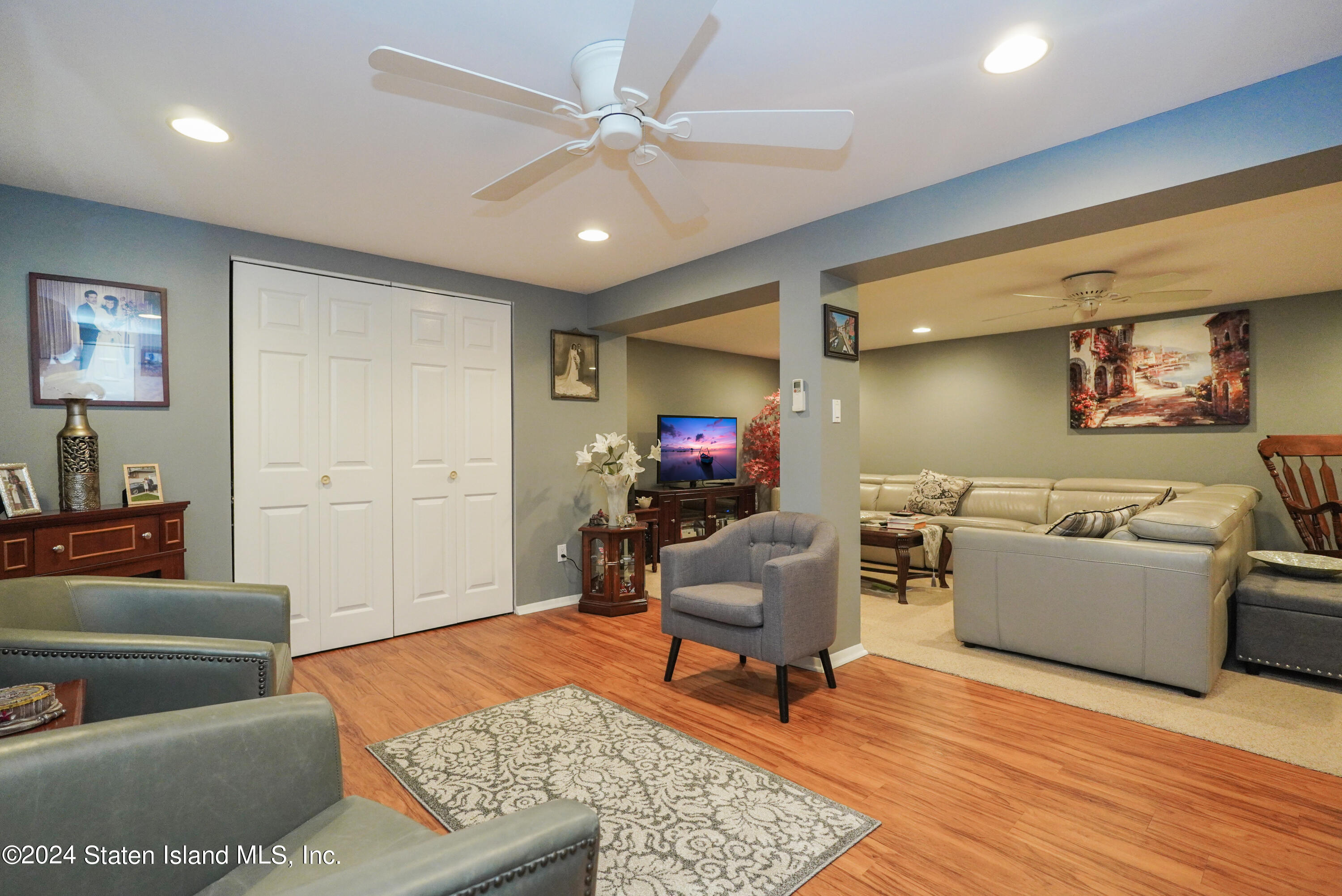 50 Ridgecrest Avenue Staten Island, NY 10312 - Photo 25 of 34 a living room with furniture and a flat screen tv