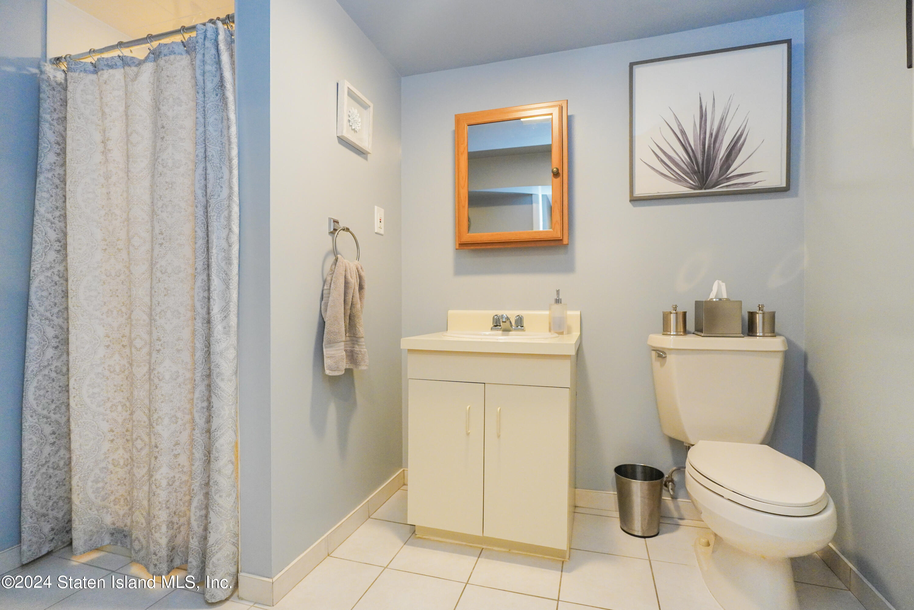 50 Ridgecrest Avenue Staten Island, NY 10312 - Photo 28 of 34 a white toilet sitting next to a bathroom sink