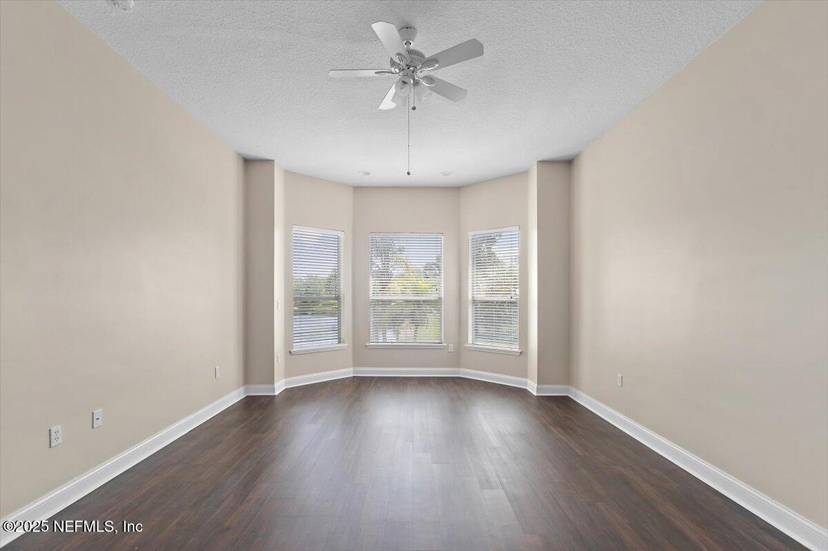 1124 Westfield Way St. Augustine, FL 32095 - Photo 14 of 29 an empty room with wooden floor and windows