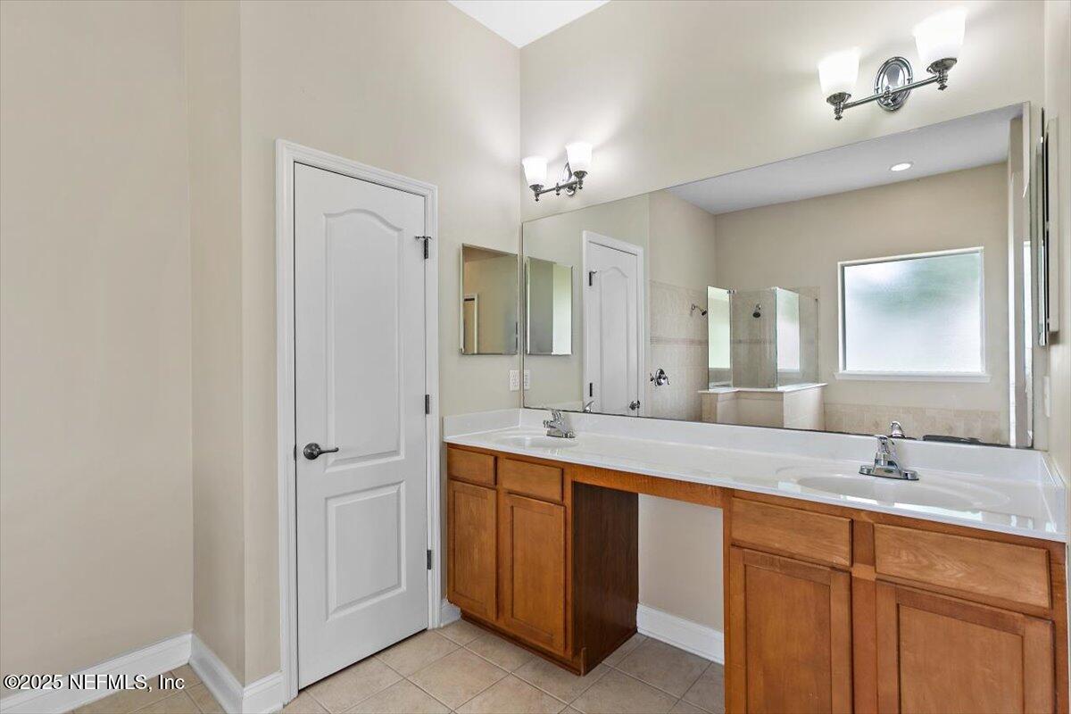 1124 Westfield Way St. Augustine, FL 32095 - Photo 16 of 29 a bathroom with a double vanity sink and a mirror
