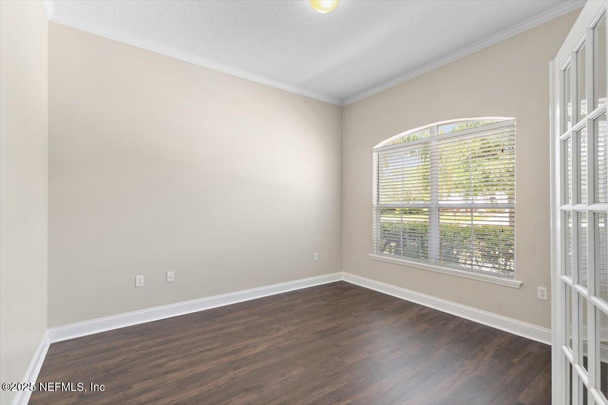 1124 Westfield Way St. Augustine, FL 32095 - Photo 3 of 29 an empty room with wooden floor and windows
