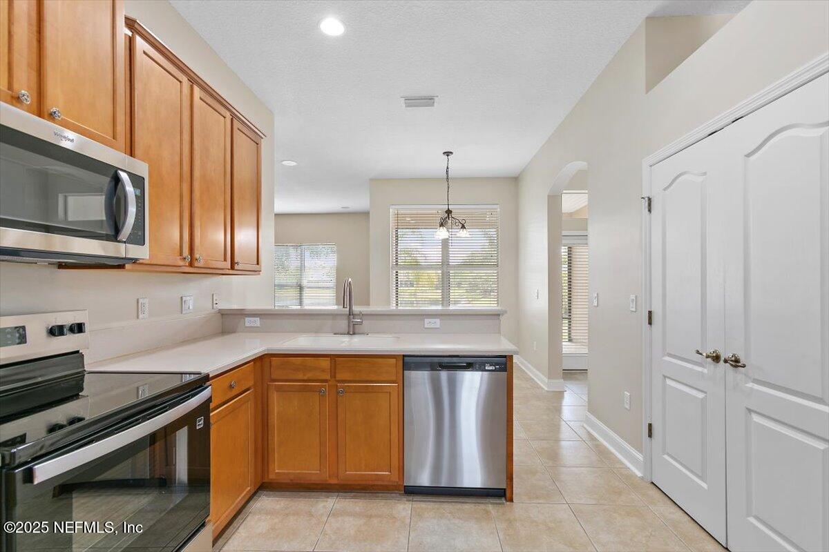 1124 Westfield Way St. Augustine, FL 32095 - Photo 9 of 29 a kitchen with a sink stove and microwave