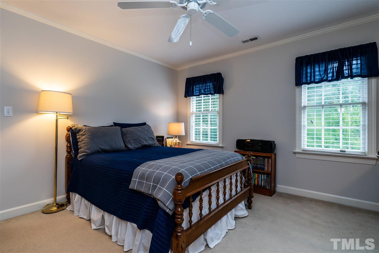 8000 Morgans Way Raleigh, NC 27615 - Photo 14 of 25 a bedroom with a bed and a window
