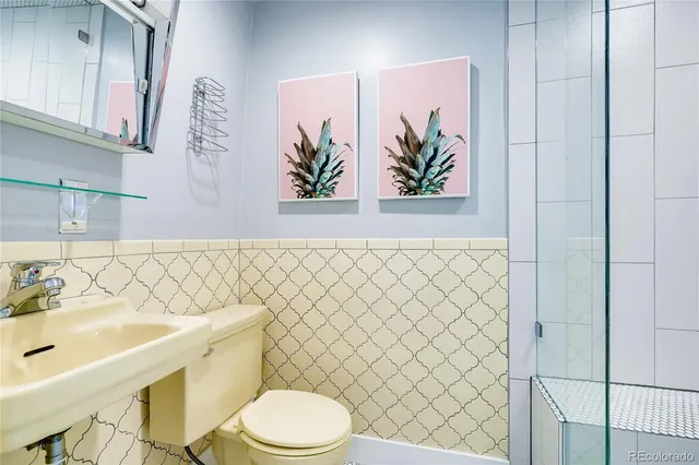 a bathroom with a sink a toilet and shower curtain