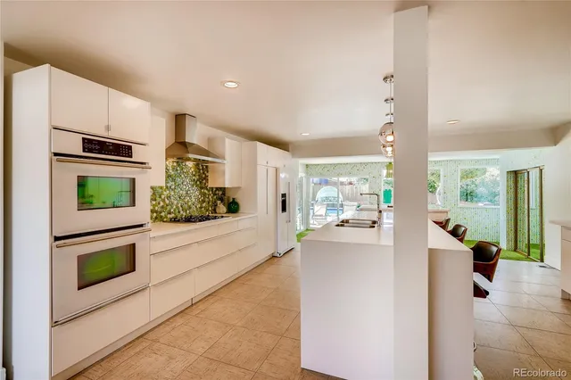 a kitchen with stainless steel appliances kitchen island granite countertop a refrigerator and a stove
