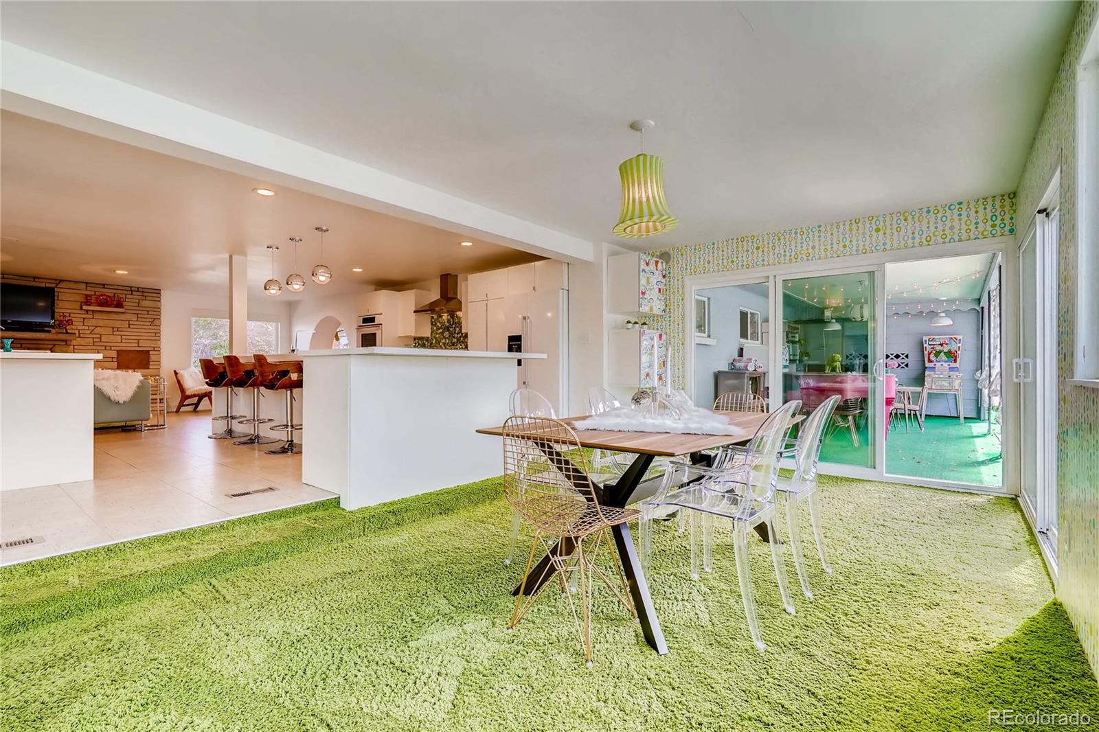 4295 North Harlan Street Wheat Ridge, CO 80033 - Photo 19 of 30 a view of a dining room with furniture and a wooden floor