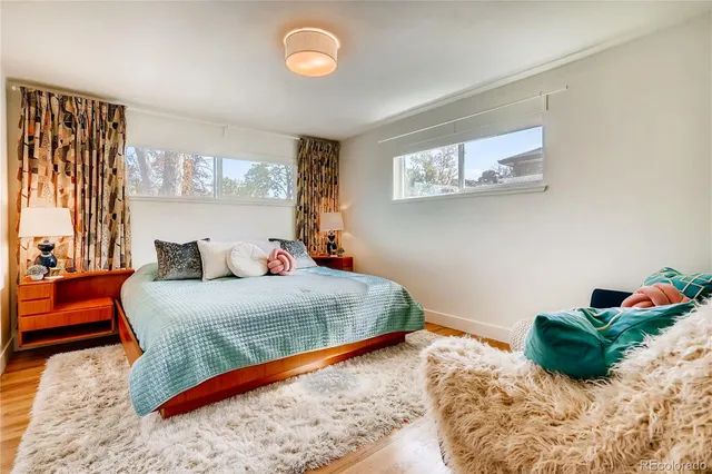 a bed sitting in a bedroom next to a window