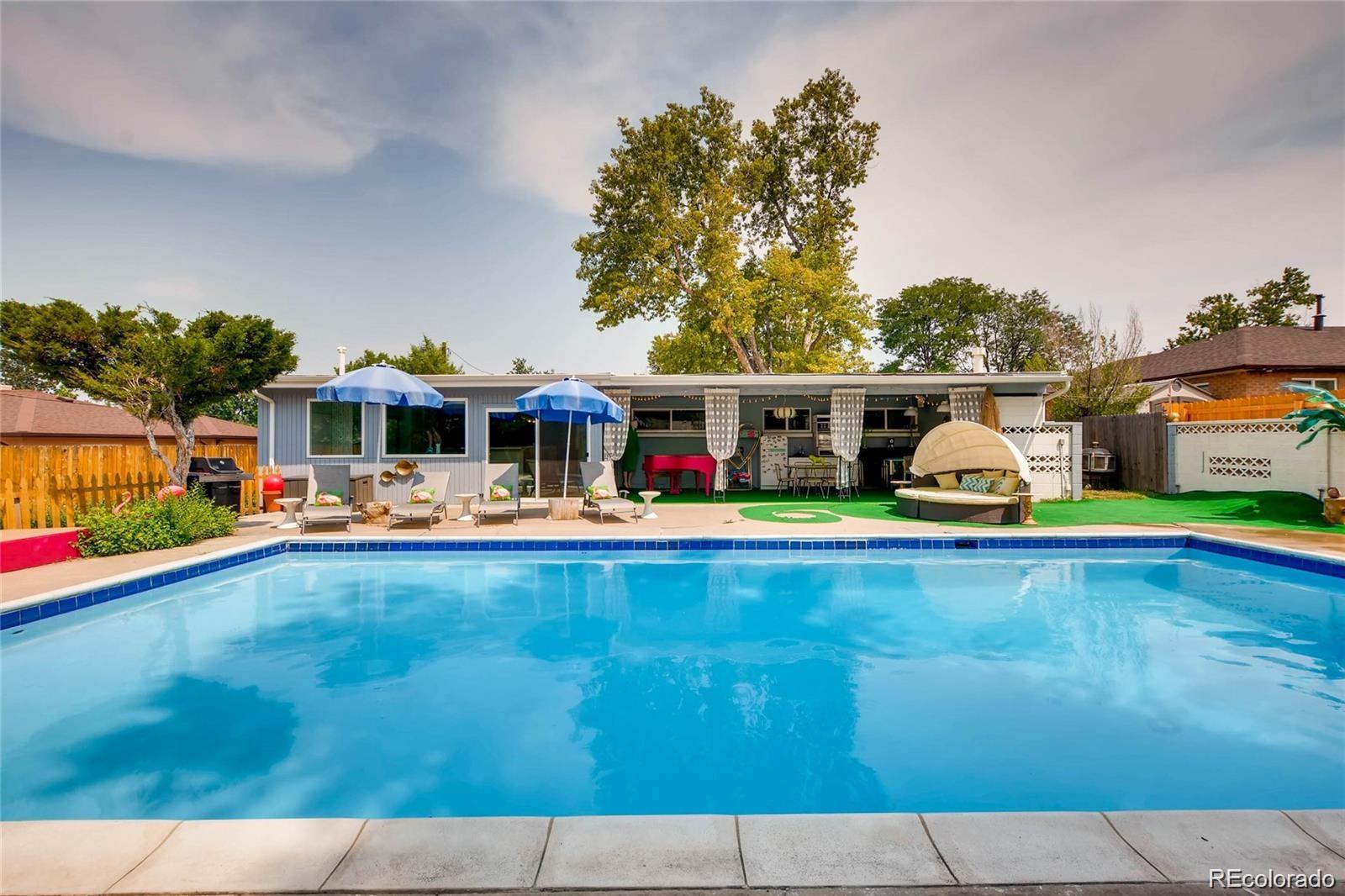 4295 North Harlan Street Wheat Ridge, CO 80033 - Photo 2 of 30 swimming pool view with a seating space and a garden view