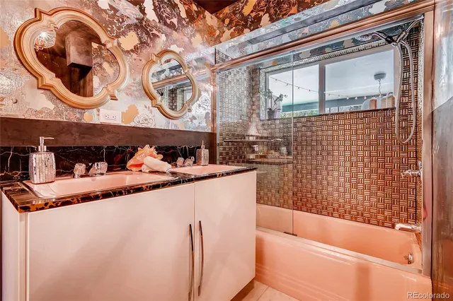 a bathroom with a granite countertop sink and a mirror