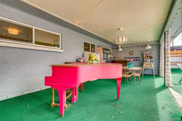 a living room with furniture a pool table and a fireplace