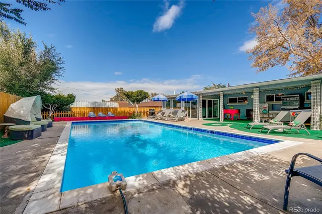 a view of a patio with table and chairs and potted plants