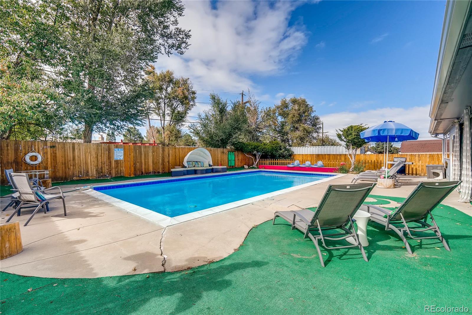4295 North Harlan Street Wheat Ridge, CO 80033 - Photo 30 of 30 a view of a swimming pool with a lounge chairs