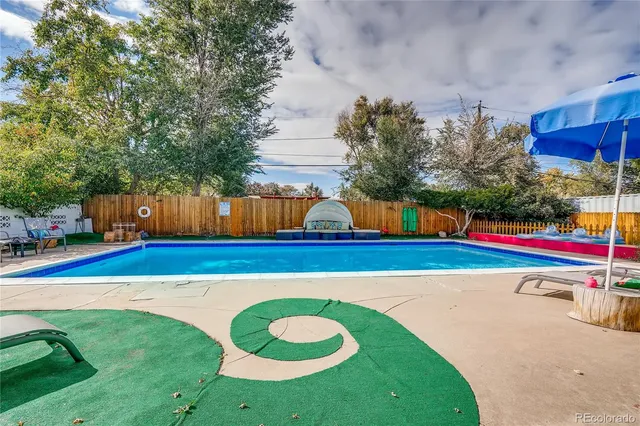 a view of yard with swimming pool and outdoor seating