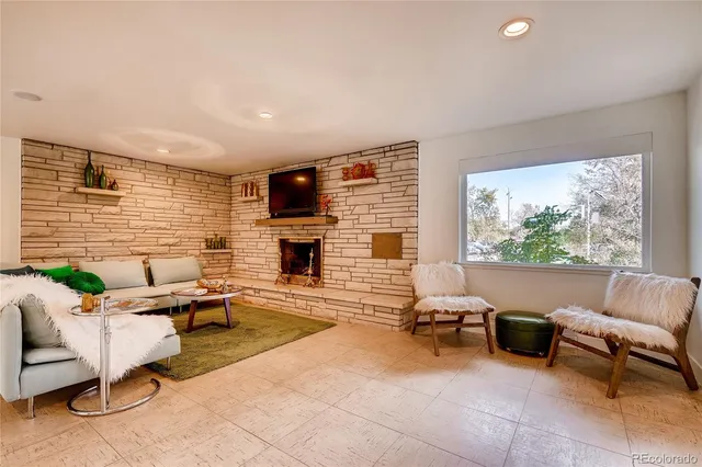a living room with furniture a fireplace and a flat screen tv