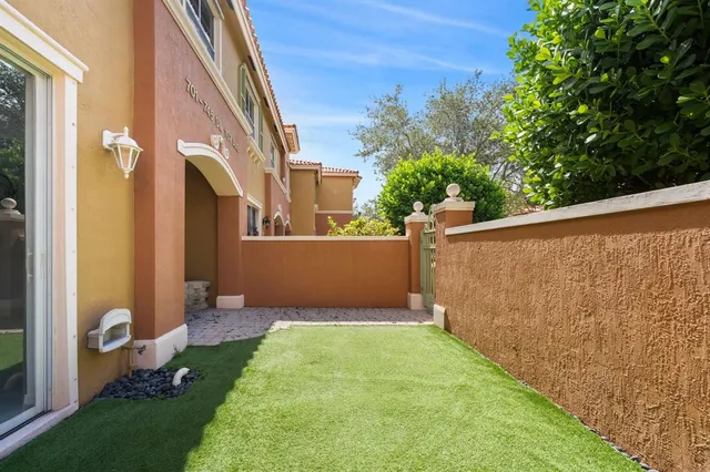 a backyard of a house with table and chairs