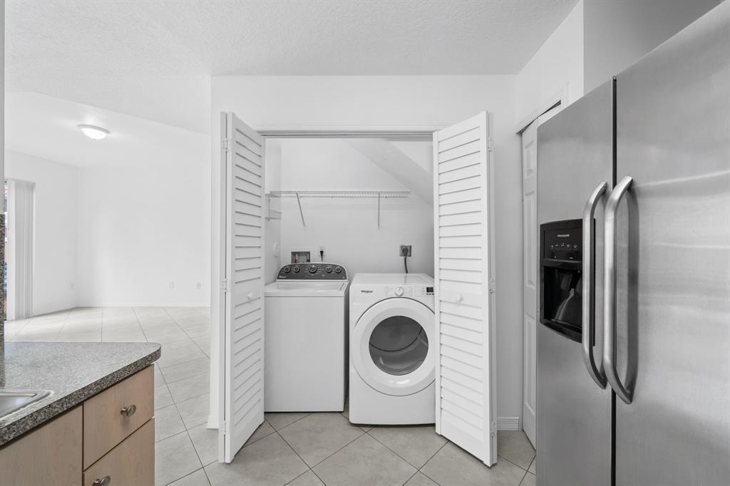 717 Southwest 107th Avenue, Unit 2203 Pembroke Pines, FL 33025 - Photo 9 of 22 a utility room with dryer and washer
