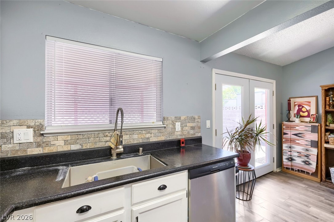 2322 Sabroso Street Las Vegas, NV 89156 - Photo 8 of 17 A well-appointed kitchen offers white cabinets and window above the sink.
