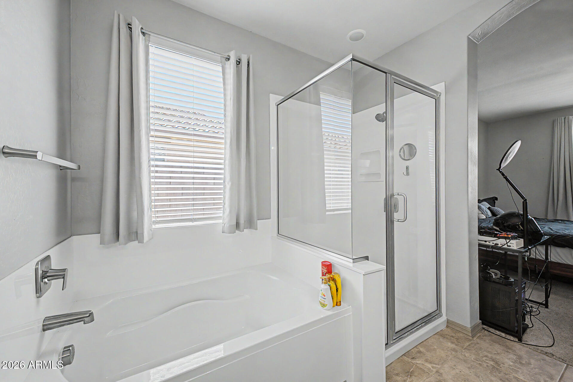 15088 West Garfield Street Goodyear, AZ 85338 - Photo 16 of 31 a bathroom with a bathtub and a shower