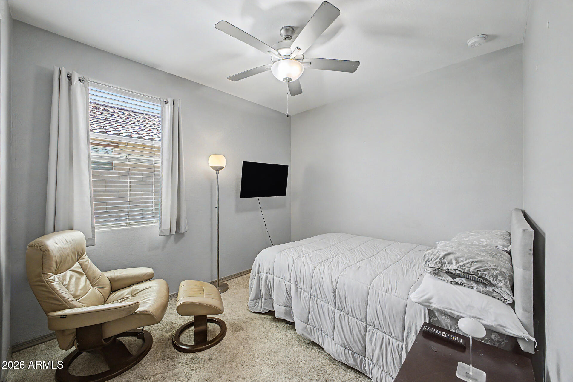 15088 West Garfield Street Goodyear, AZ 85338 - Photo 18 of 31 a bedroom with a bed and a couch
