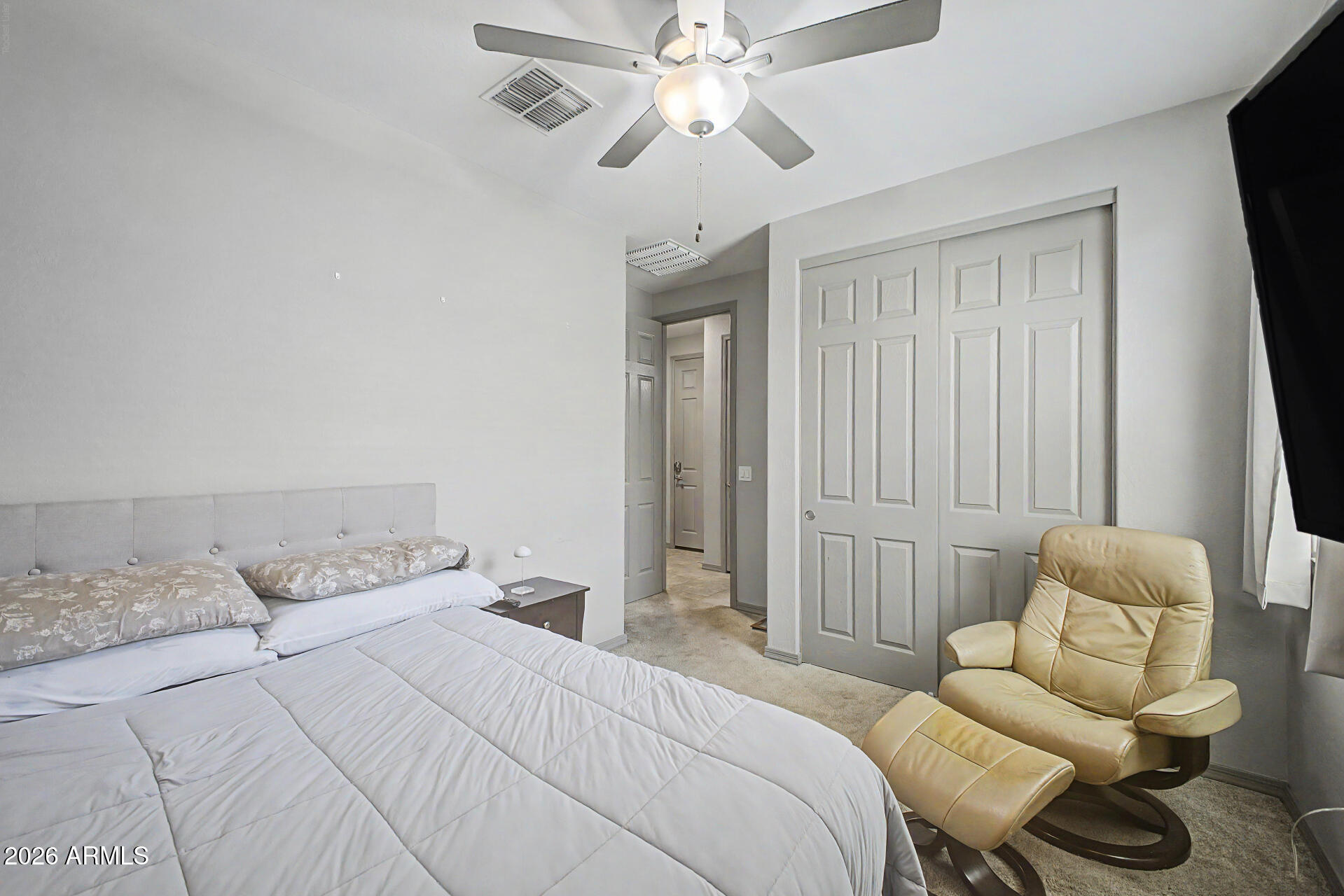 15088 West Garfield Street Goodyear, AZ 85338 - Photo 19 of 31 a bedroom with a bed and a couch