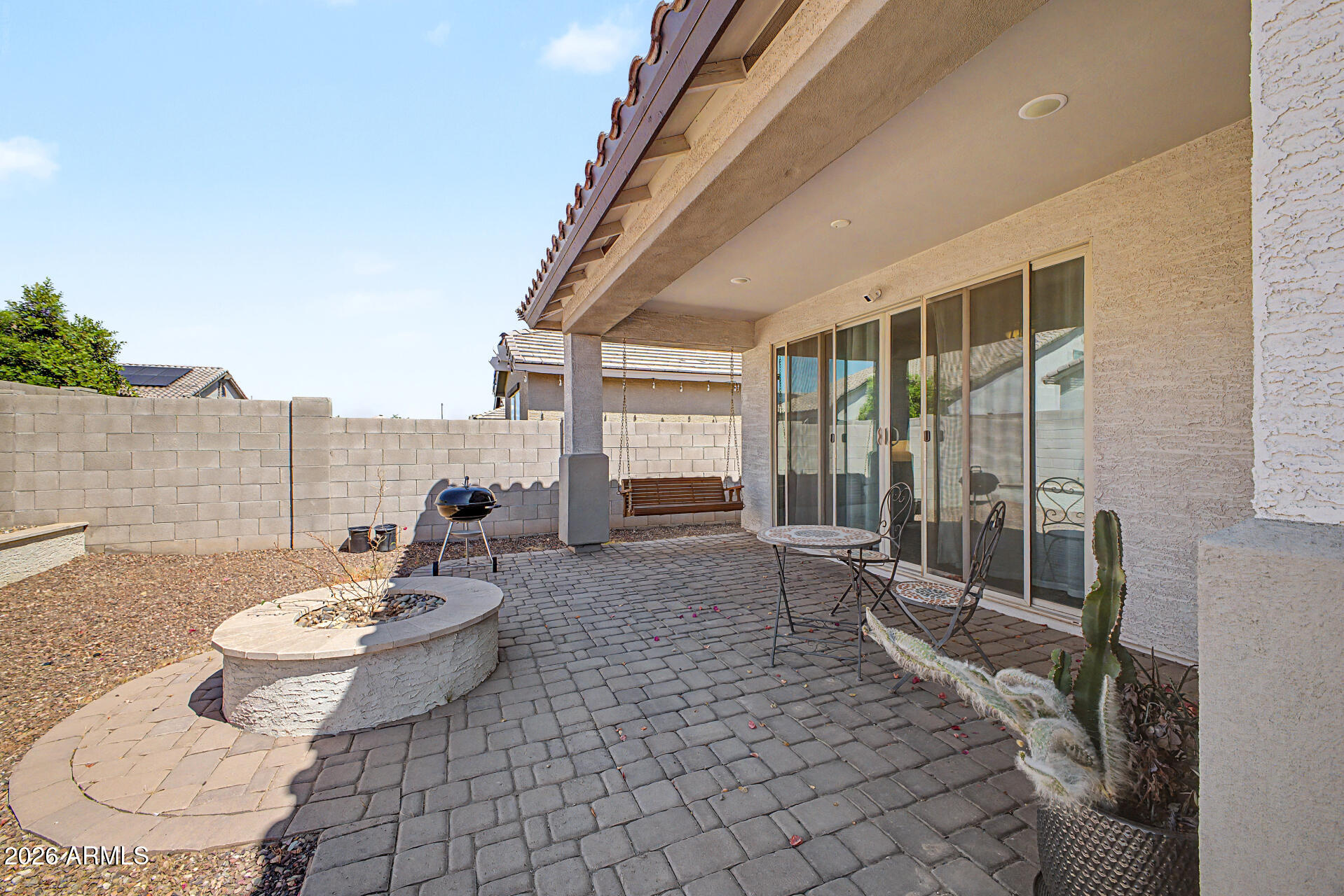 15088 West Garfield Street Goodyear, AZ 85338 - Photo 28 of 31 a living room with furniture and a floor to ceiling window