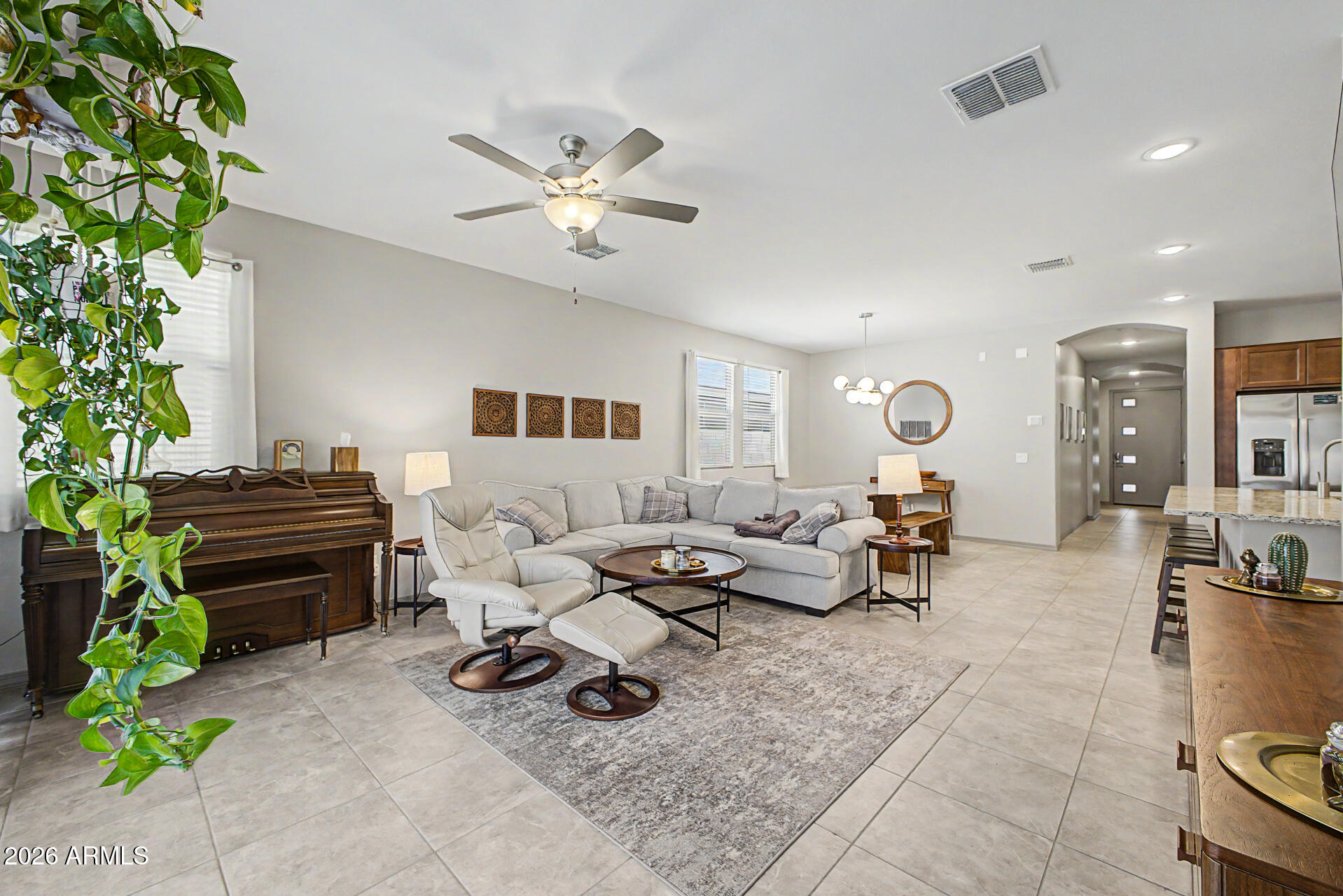 15088 West Garfield Street Goodyear, AZ 85338 - Photo 5 of 31 a living room with furniture flowerpot and a potted plant