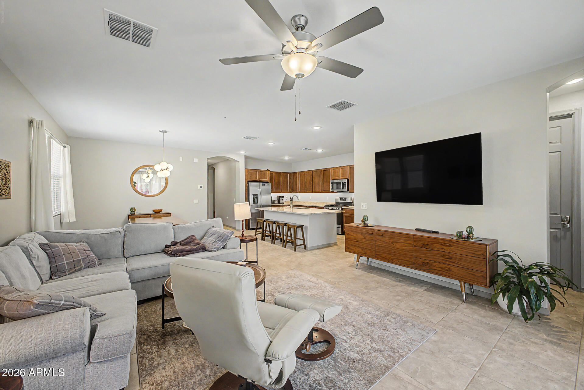 15088 West Garfield Street Goodyear, AZ 85338 - Photo 6 of 31 a living room with furniture and a flat screen tv