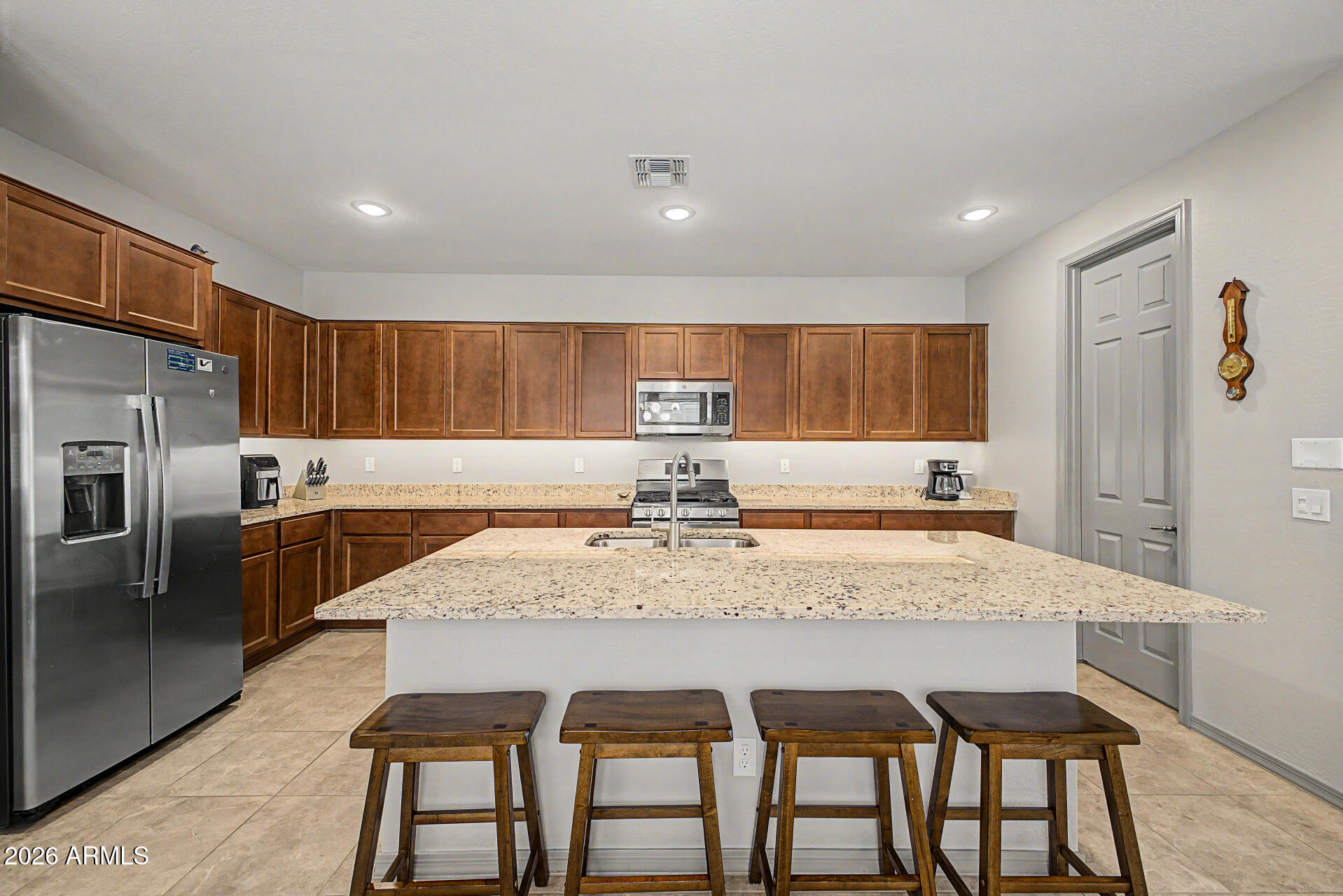 15088 West Garfield Street Goodyear, AZ 85338 - Photo 8 of 31 a large kitchen with a table and chairs