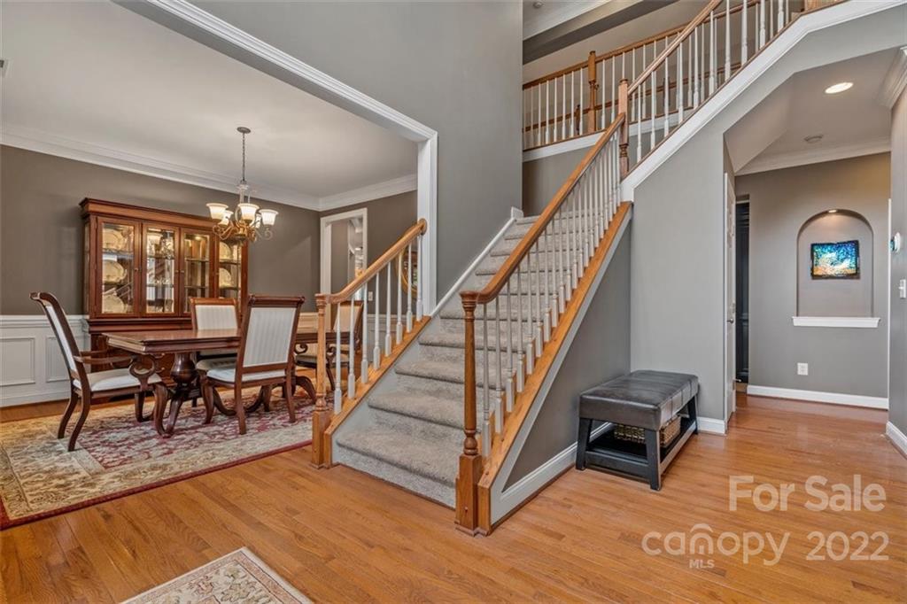 232 Choate Avenue Fort Mill, SC 29708 - Photo 6 of 47 a view of a hallway with wooden floor and stairs