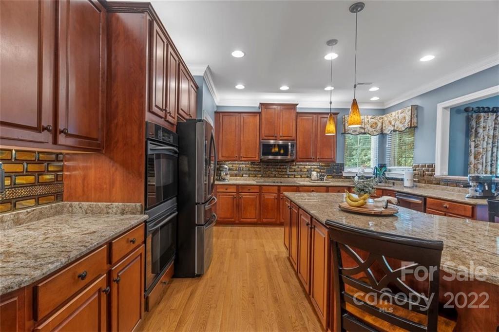 232 Choate Avenue Fort Mill, SC 29708 - Photo 8 of 47 a kitchen with stainless steel appliances granite countertop a stove a sink and a refrigerator