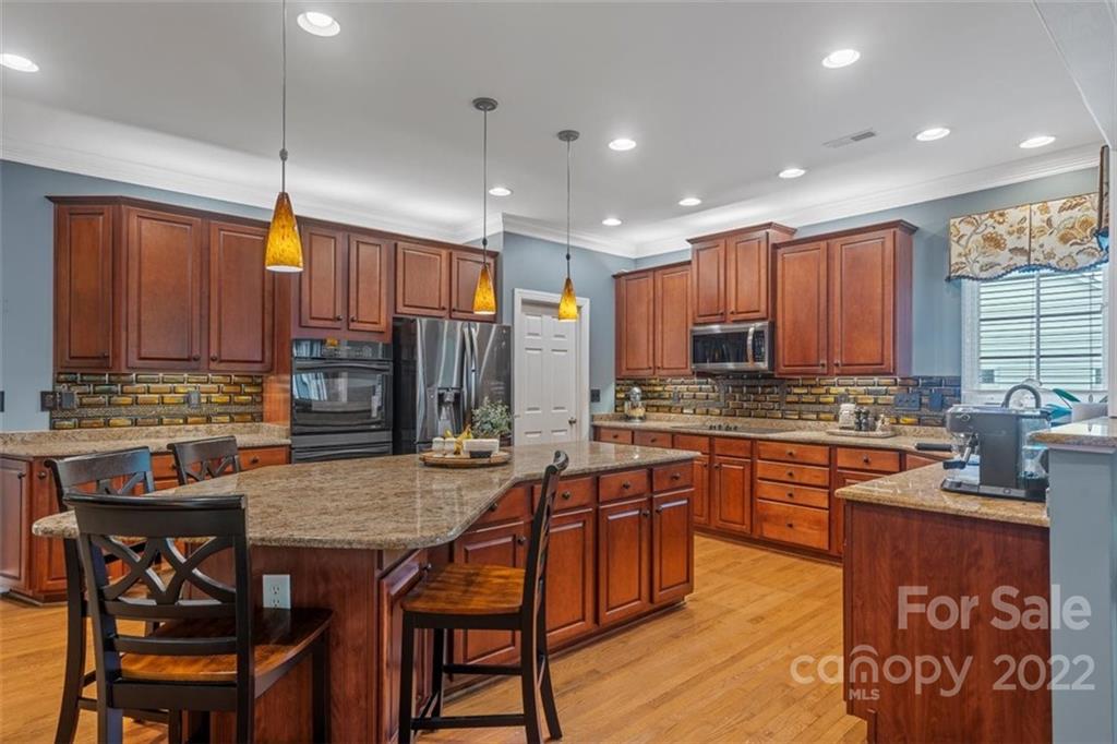 232 Choate Avenue Fort Mill, SC 29708 - Photo 10 of 47 a kitchen with stainless steel appliances granite countertop wooden cabinets a stove a sink and a refrigerator