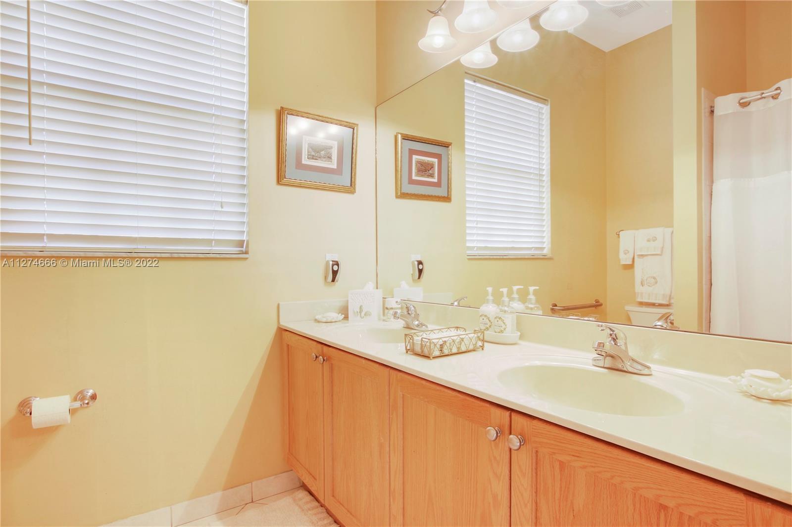 116 Via Rosina Jupiter, FL 33458 - Photo 19 of 32 a bathroom with a granite countertop sink and a mirror