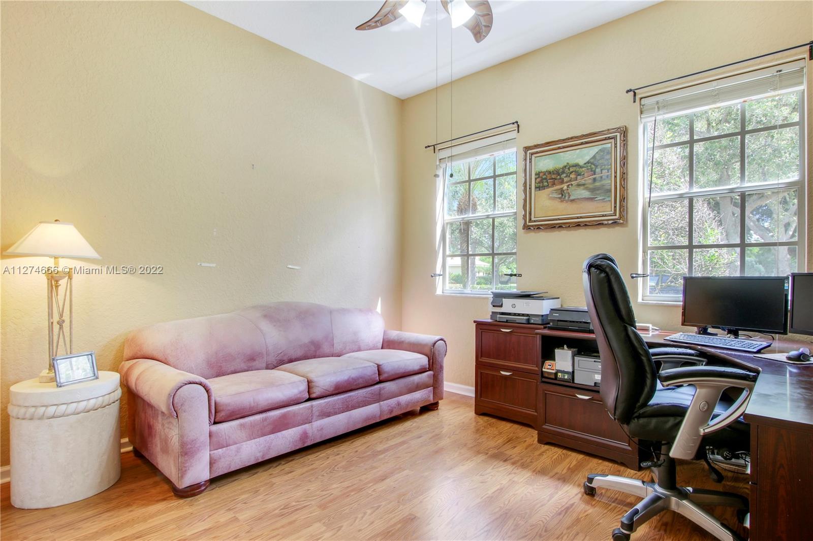 116 Via Rosina Jupiter, FL 33458 - Photo 20 of 32 a living room with furniture a desk and a window