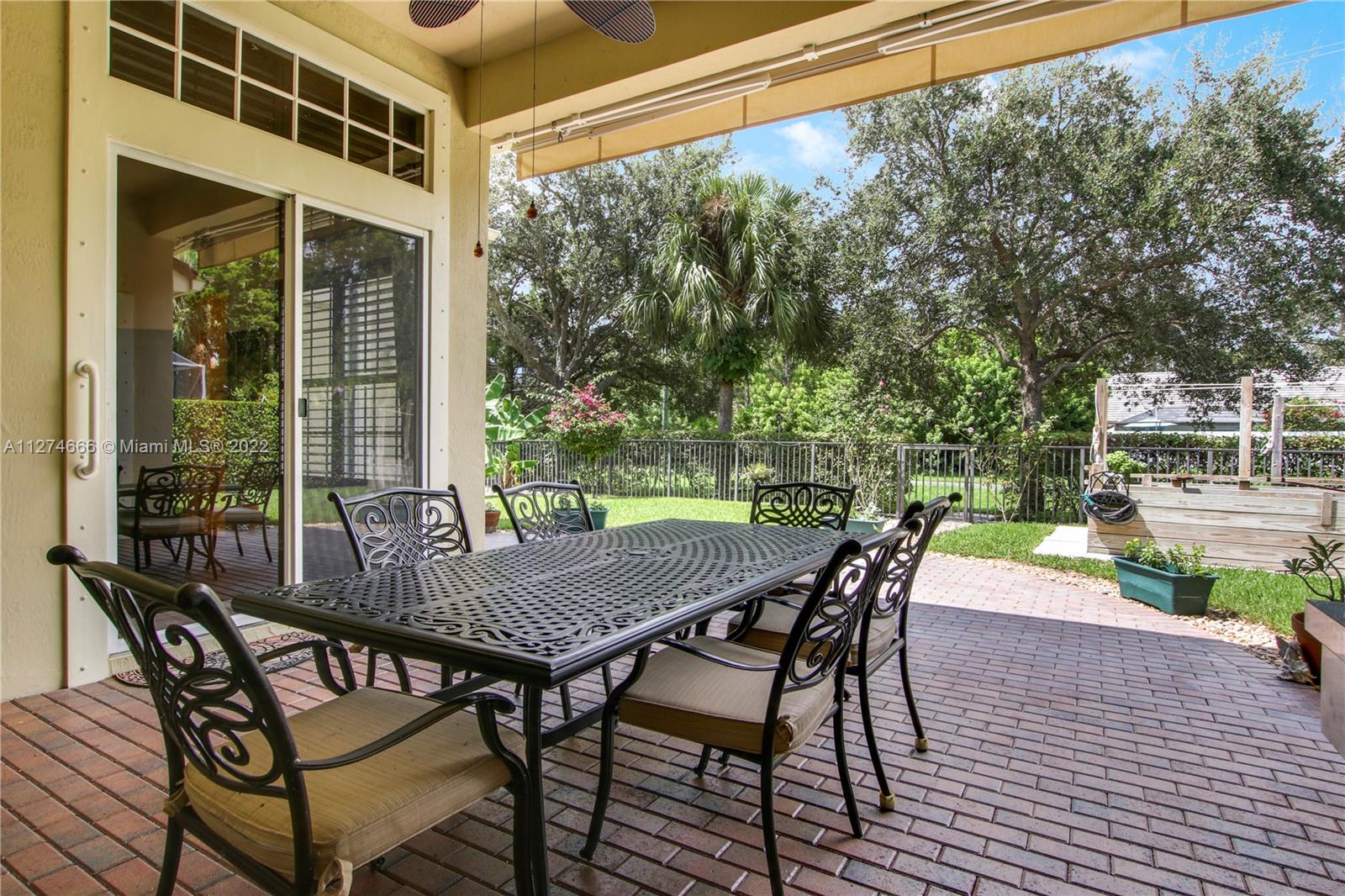 116 Via Rosina Jupiter, FL 33458 - Photo 22 of 32 a view of an outside dining space with a table and chairs