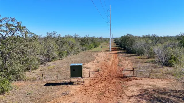 a view of a dry yard with mountain view