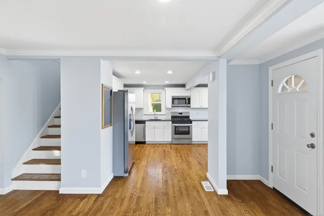 a view of kitchen with wooden floor and electronic appliances