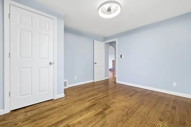 a view of an empty room and wooden floor