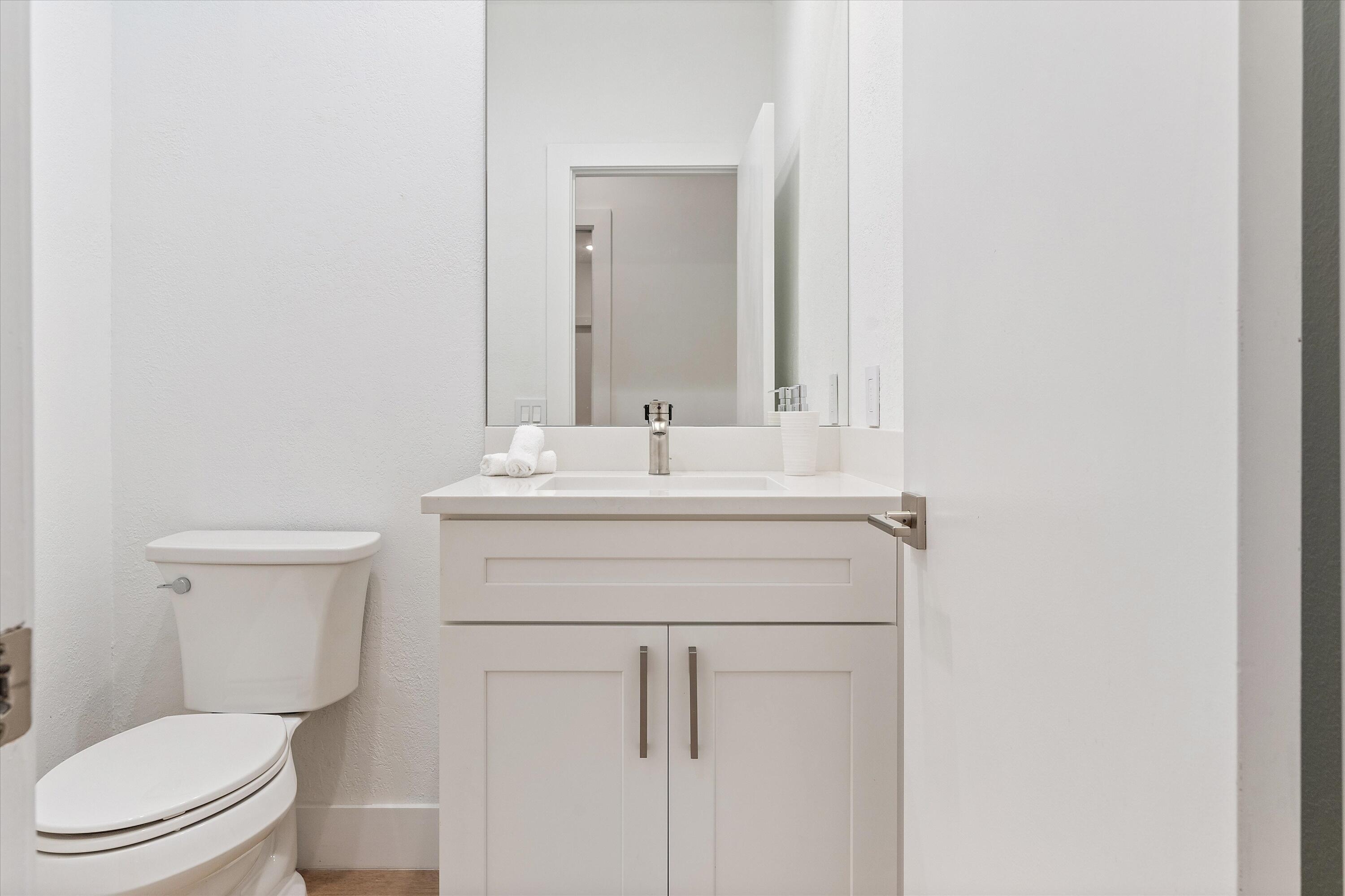2299 Northwest 30th Road Boca Raton, FL 33431 - Photo 15 of 50 a bathroom with a toilet sink vanity and mirror