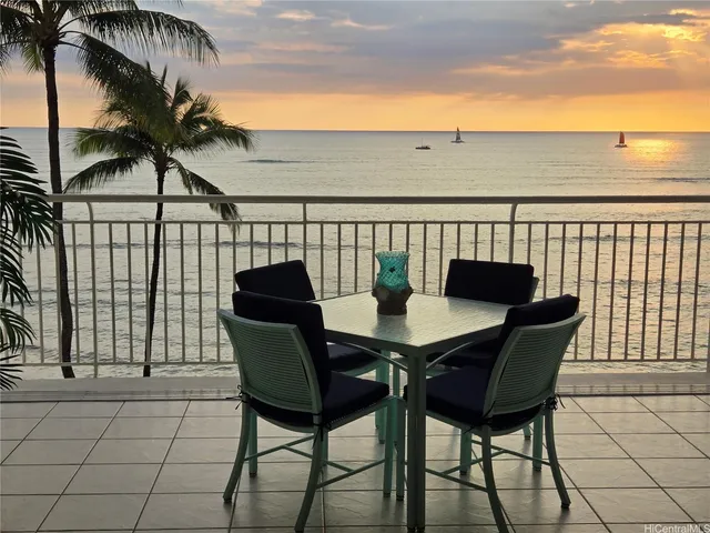 a view of a chairs and table in the balcony