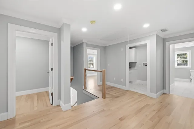 a view of empty room with wooden floor