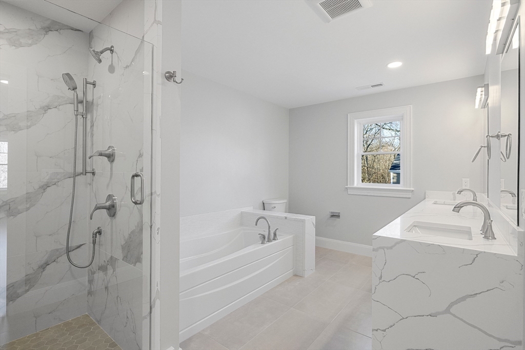 4 Aerial Street Lexington, MA 02421 - Photo 20 of 35 a bathroom with a bathtub and a shower