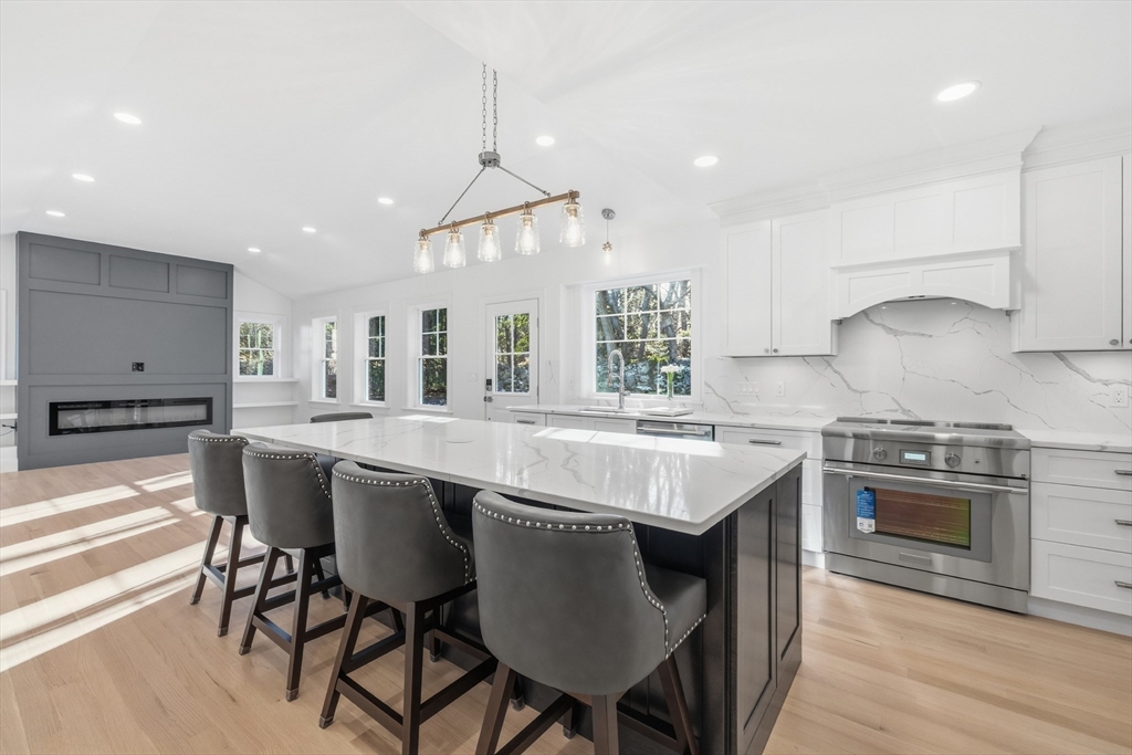 4 Aerial Street Lexington, MA 02421 - Photo 2 of 35 a kitchen with a dining table chairs stainless steel appliances and cabinets