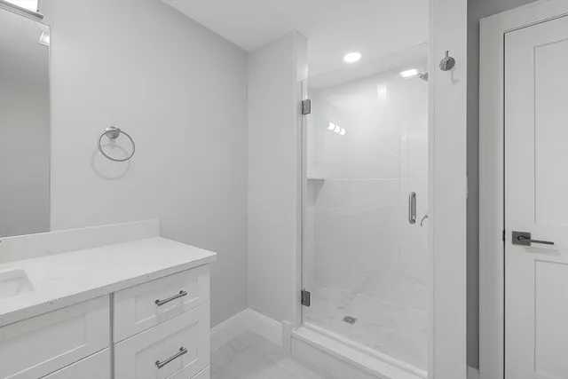 a bathroom with a shower and vanity