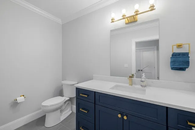 a bathroom with a sink a toilet and mirror