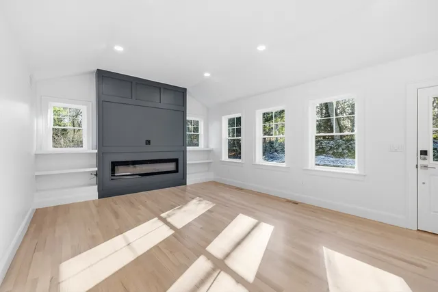 a view of a bedroom with furniture and windows
