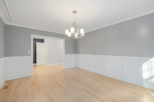 a view of a chandelier in big room and chandelier