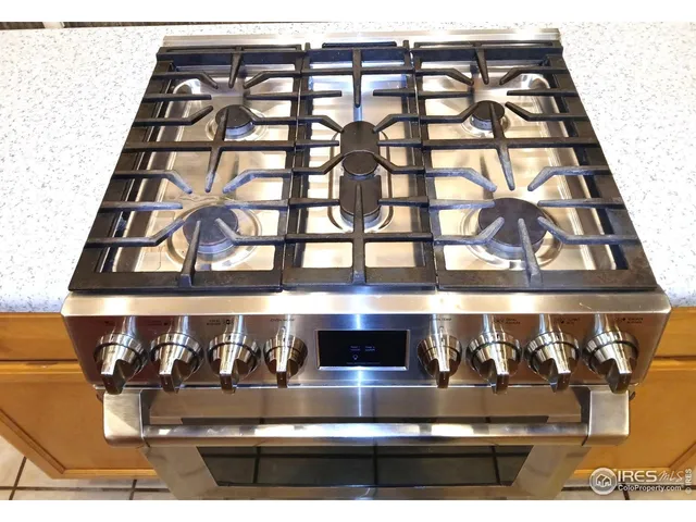 a kitchen with a sink cabinets and a wooden floor