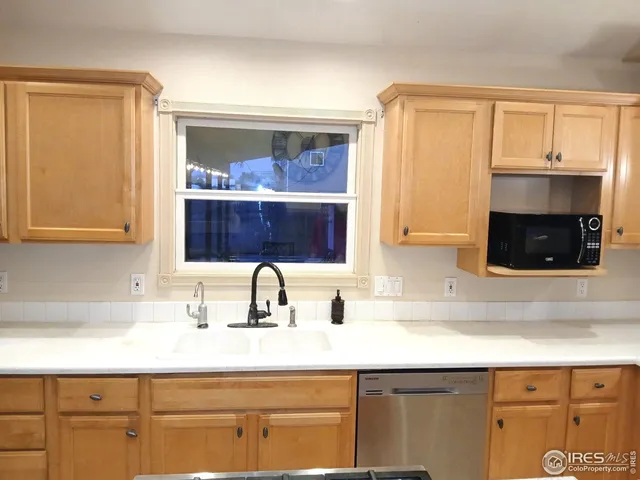 a kitchen with stainless steel appliances a stove and a sink