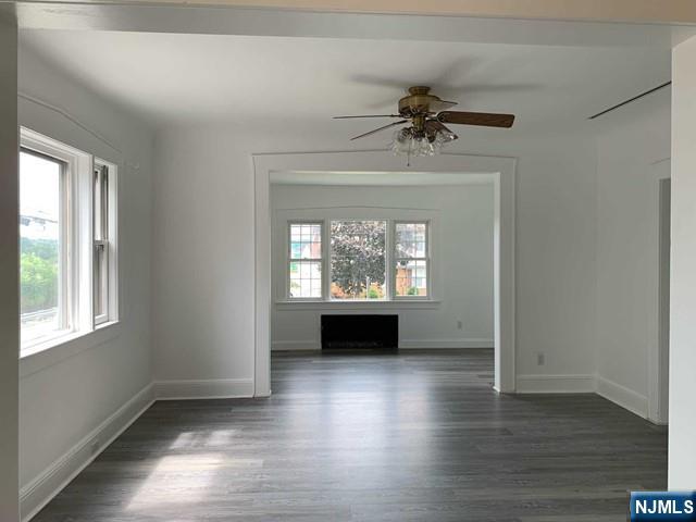 73 East Gouverneur Avenue Rutherford, NJ 07070 - Photo 11 of 33 an empty room with wooden floor chandelier and windows