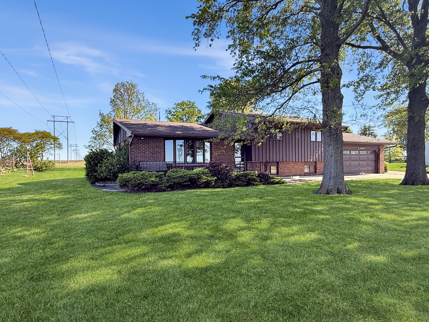 2052 County Road 3000 North Rantoul, IL 61866 - Photo 2 of 21 a front view of a house with garden